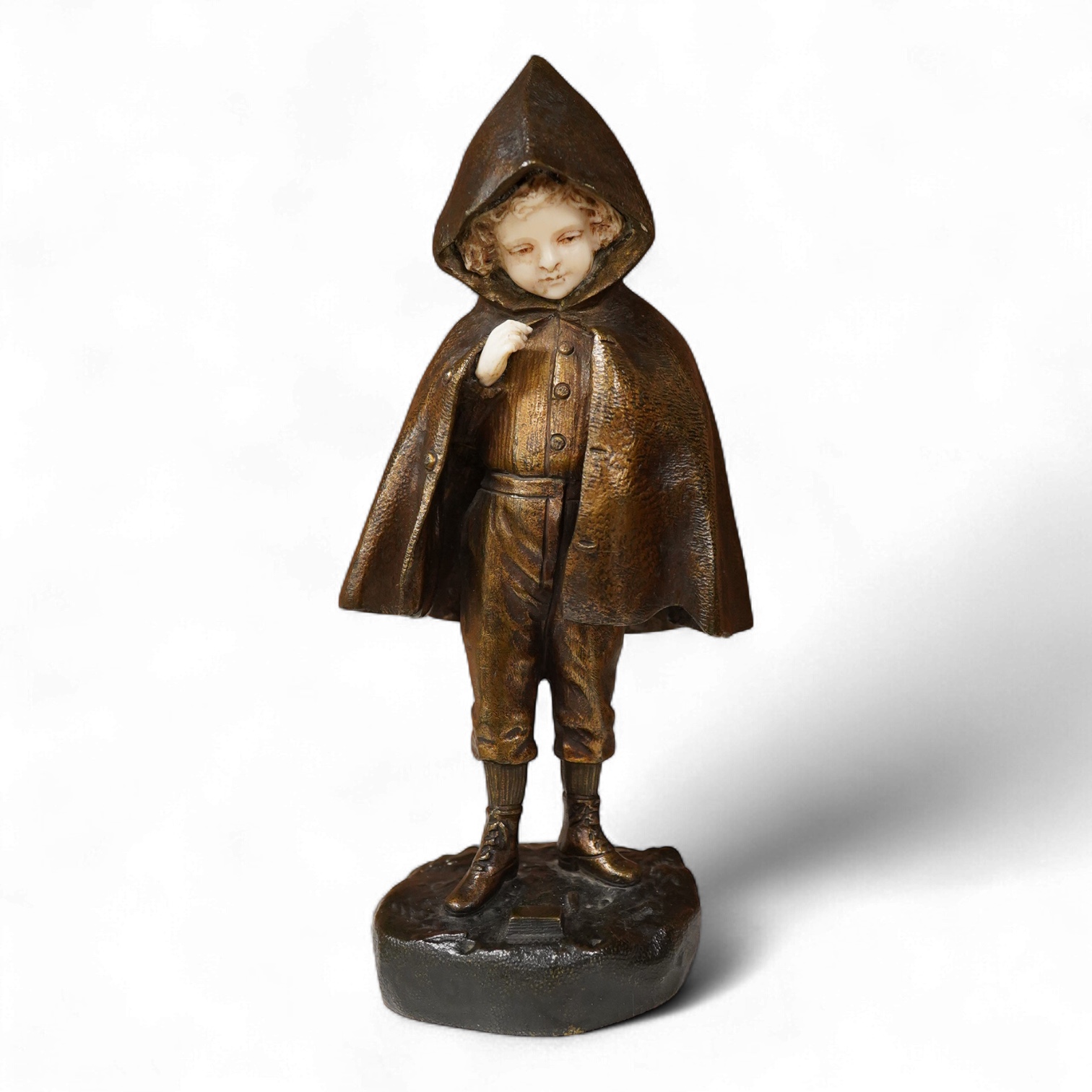 An Art Deco bronze and ivory figure of a boy wearing a cloak, signed Chopard, 22cm high CITES Submission reference, B3J6ULYT